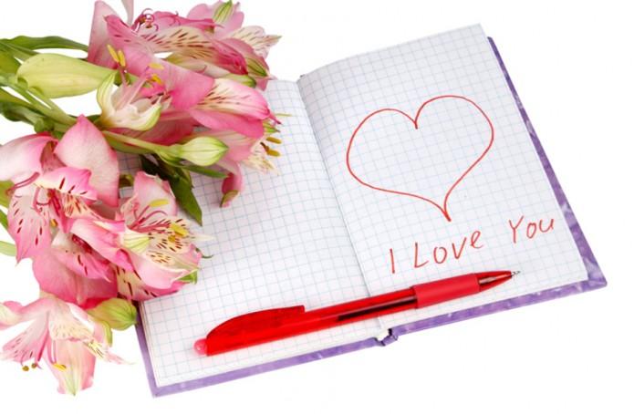 notebook with flowers by a heart and inscription