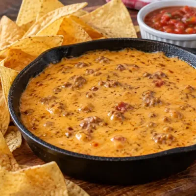 Copycat Chili’s Skillet Beef Queso served warm with tortilla chips