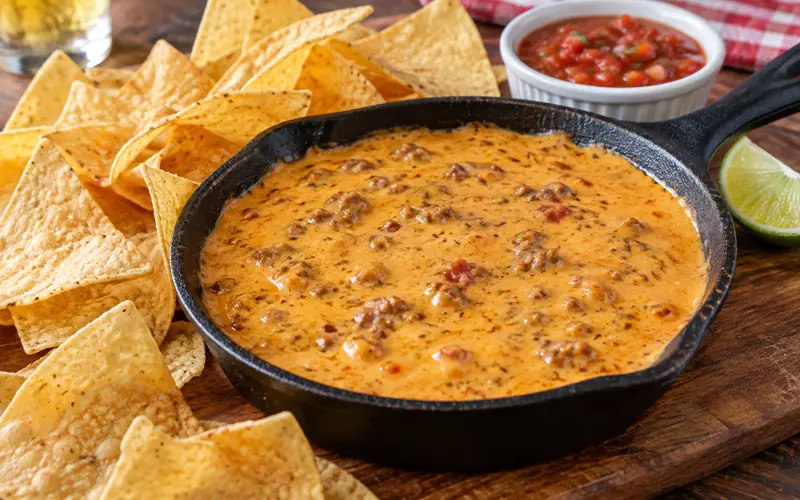 Copycat Chili’s Skillet Beef Queso served warm with tortilla chips