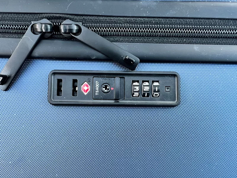 Close-up of the LEVEL8 suitcase TSA-approved combination lock and zipper pulls.