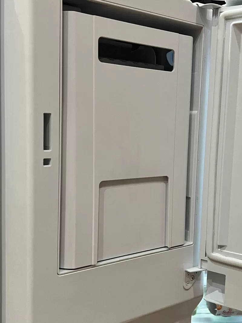 GE GFE26JYMFS refrigerator built-in ice maker compartment inside the refrigerator door