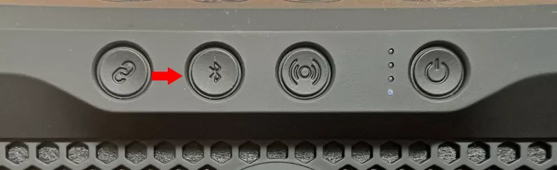 Bluetooth pairing button on the ROCKSTER CROSS speaker with an arrow pointing to the button
