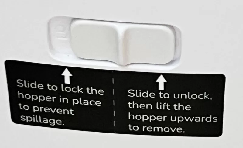 Lock switch on the WOPet F07 Pro feeder showing how to unlock and remove the food hopper.