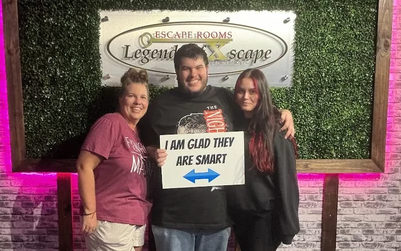Three people posing together after an escape room visit at Legends of Xscape in West Palm Beach.