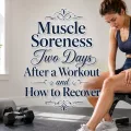 Woman seated on a workout bench gently massaging her sore thigh after strength training.