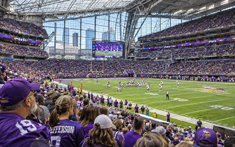 Minnesota Vikings football game inside U.S. Bank Stadium in Minneapolis with fans filling the stands.